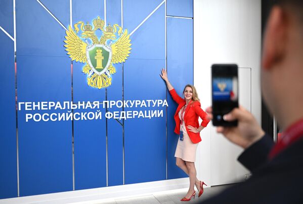 SPIEF-2023: A forum participant poses for a photo at the stand of the Prosecutor General&#x27;s Office of the Russian Federation at the exhibition of the 26th St. Petersburg International Economic Forum. - Sputnik Africa