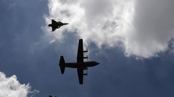 An aircraft carrying the casket of former South African President Nelson Mandela is escorted by fighter jets after taking off from Waterkloof Air Base on the outskirts of Pretoria, South Africa, Saturday, Dec. 14, 2013. - Sputnik Africa