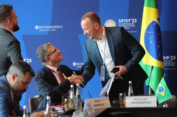 SPIEF-2023: (From left) Almir Ameriko (sitting), head of the Moscow office of Brazi&#x27;s Export Development Agency &quot;Apex Brazil&quot; shakes hands with Alexander Sharabaiko, board member and deputy general director for finance and international projects, PJSC &quot;PhosAgro&quot; speak at the session, Russia - Brazil, on 14 June. - Sputnik Africa