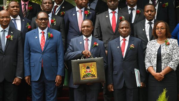 Kenya's Cabinet Secretary for National Treasury Njuguna Ndung'u (with briefcase) poses with the budget briefcase before leaving for Parliament to read the budget speech for 2022-2023 in Nairobi on June 15, 2023 in Nairobi.  - Sputnik Africa