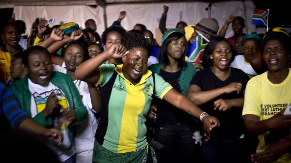Youth members of the African National Congress (ANC) dance, pray and sing songs honoring Nelson Mandela, at a nighttime vigil at the Walter Sisulu University in Mthatha, South Africa, Saturday, Dec. 14, 2013.  - Sputnik Africa