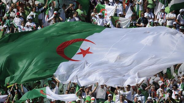 Algerian fans unfurl a giant Algerian flag during their Group C first round 2010 World Cup football match on June 13, 2010 at Peter Mokaba stadium in Polokwane. - Sputnik Africa
