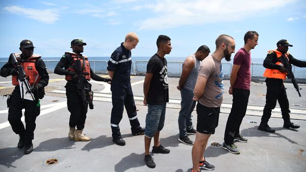 The Nigerian Navy Special forces pretend to arrest pirates in F375 Germinal French Frigate in a stage managed operations during the five-day joint military exercise between Nigeria and French navy codenamed Grand African NEMO (Navy Exercise Maritime Operations) in Nigerian waters on November 1, 2019 - Sputnik Africa