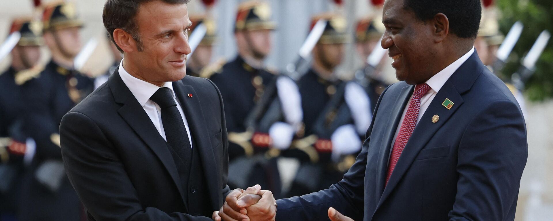 French President Emmanuel Macron (L) shakes hands to greet Zambia's President Hakainde Hichilema upon arrival for an official dinner at the Elysee Palace, on the sidelines of the New Global Financial Pact Summit, in Paris, on June 22, 2023.  - Sputnik Africa, 1920, 23.06.2023