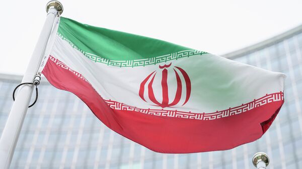 The flag of Iran waves in front of the the International Center building with the headquarters of the International Atomic Energy Agency, IAEA, in Vienna, Austria, May 24, 2021.  (AP Photo/Florian Schroetter, FILE) - Sputnik Africa