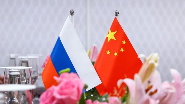 Russian and Chinese flags at the meeting between Russian Foreign Minister Sergey Lavrov and Chinese Foreign Minister Qin Gang on the sidelines of the G20 foreign ministers meeting at the Cultural Center of the Presidential Palace in New Delhi. - Sputnik Africa