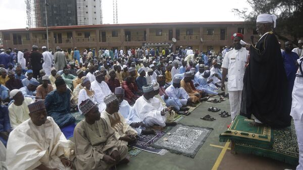 Nigeria muslims offer Eid al-Adha prayers at a basketball court in Lagos, Nigeria, Tuesday, July 20, 2021. During Eid al-Adha, or Feast of Sacrifice, Muslims slaughter sheep or cattle and distribute portions of the meat to the poor. - Sputnik Africa