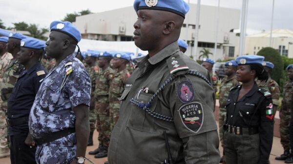 African soldiers and police who helped France take back control of Mali's north earlier this year participate in a ceremony formally transforming the force into a United Nations peacekeeping mission, in Bamako, Mali, Monday, July 1, 2013. T - Sputnik Africa