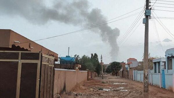 Smoke billows in the distance amid ongoing fighting in Khartoum on June 13, 2023 - Sputnik Africa