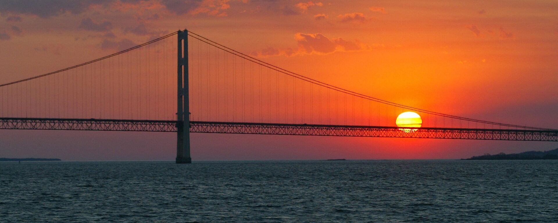 In this May 31, 2002 file photo, the sun sets over the Mackinac Bridge and the Mackinac Straits as seen from Lake Huron. - Sputnik Africa, 1920, 04.07.2023
