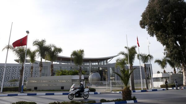 A police officer rides his motorcycle in front of the International Conference Center where the signing of a U.N.-sponsored deal aiming to end Libya's conflict is expected to take place, Wednesday, Dec.16, 2015 in Sikhrat, Morocco.  - Sputnik Africa