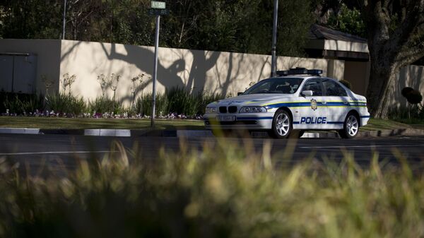 Police officers sit guard in a patrol car parked outside the residence of former South African President Nelson Mandela in Johannesburg, South Africa, Thursday, Sept. 5, 2013. - Sputnik Africa