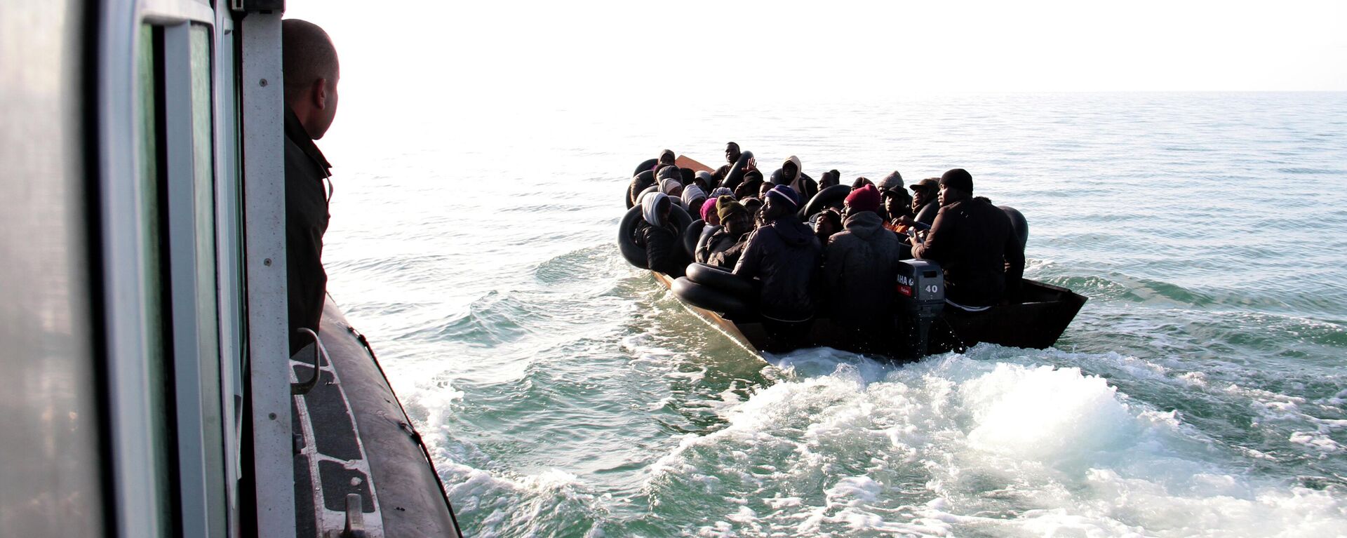 Migrants, mainly from sub-Saharan Africa, are stopped by Tunisian Maritime National Guard at sea during an attempt to get to Italy, near the coast of Sfax, Tunisia, Tuesday, April 18, 2023. - Sputnik Africa, 1920, 16.07.2023