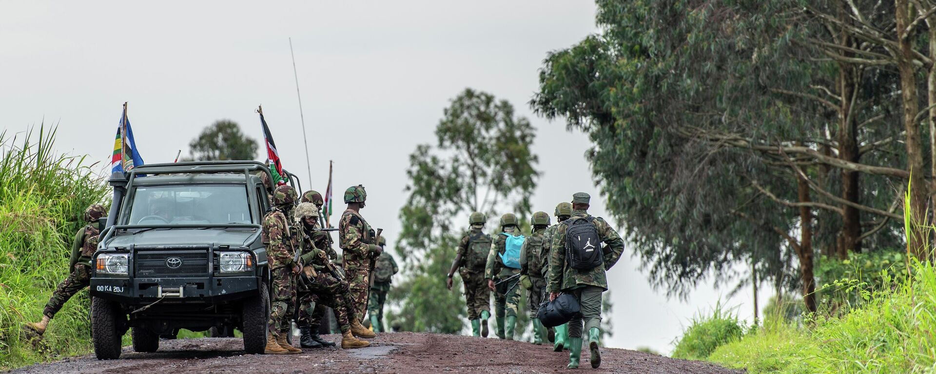 Members of East African Community Regional Force (EACRF), left, watch the M23 rebels leaving after a ceremony to mark the withdrawal from their positions in the town of Kibumba, in the eastern of Democratic Republic of Congo, Friday, Dec. 23, 2022.  - Sputnik Africa, 1920, 18.07.2023