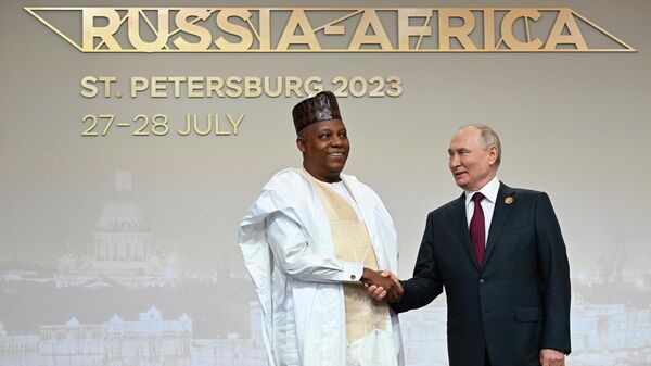 Russian President Vladimir Putin and Nigerian Vice President Kashim Shettima during a greeting before the official meeting ceremony of the heads of delegations participating in the second  Russia-Africa Summit in St. Petersburg - Sputnik Africa