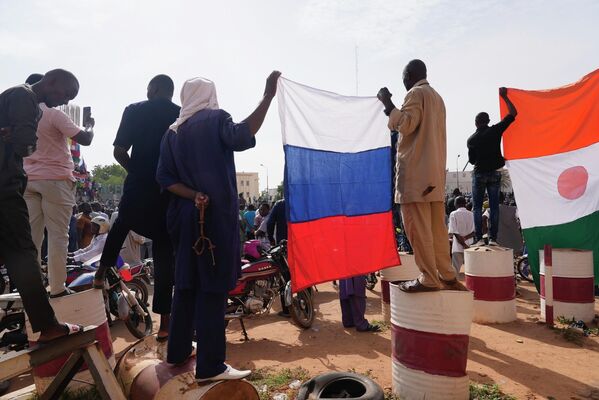 Nigeriens holding a Russian flag participate in a march by supporters of the nation&#x27;s military leader Gen. Abdourahmane Tchiani in the country&#x27;s capital Niamey, Niger, Sunday, July 30, 2023.  - Sputnik Africa