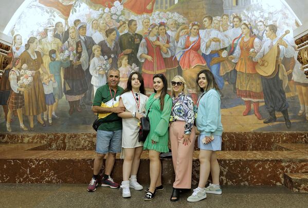 Tourists take snapshots of the Kievskaya metro station&#x27;s fresco entitled &quot;People&#x27;s festivities in Kiev&quot; in Moscow, Russia, July 28, 2023. - Sputnik Africa