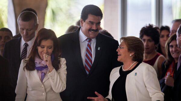 Argentina's Cristina Fernandez, left, Venezuela's Nicolas Maduro, center, and Chile's Michelle Bachelet, make their way to the staging area for the official group photo comprised of the leaders of the BRICS' nations and Mercosur nations, during the BRICS summit at the Itamaraty Palace, in Brasilia, Brazil, Wednesday, July 16, 2014.  - Sputnik Africa