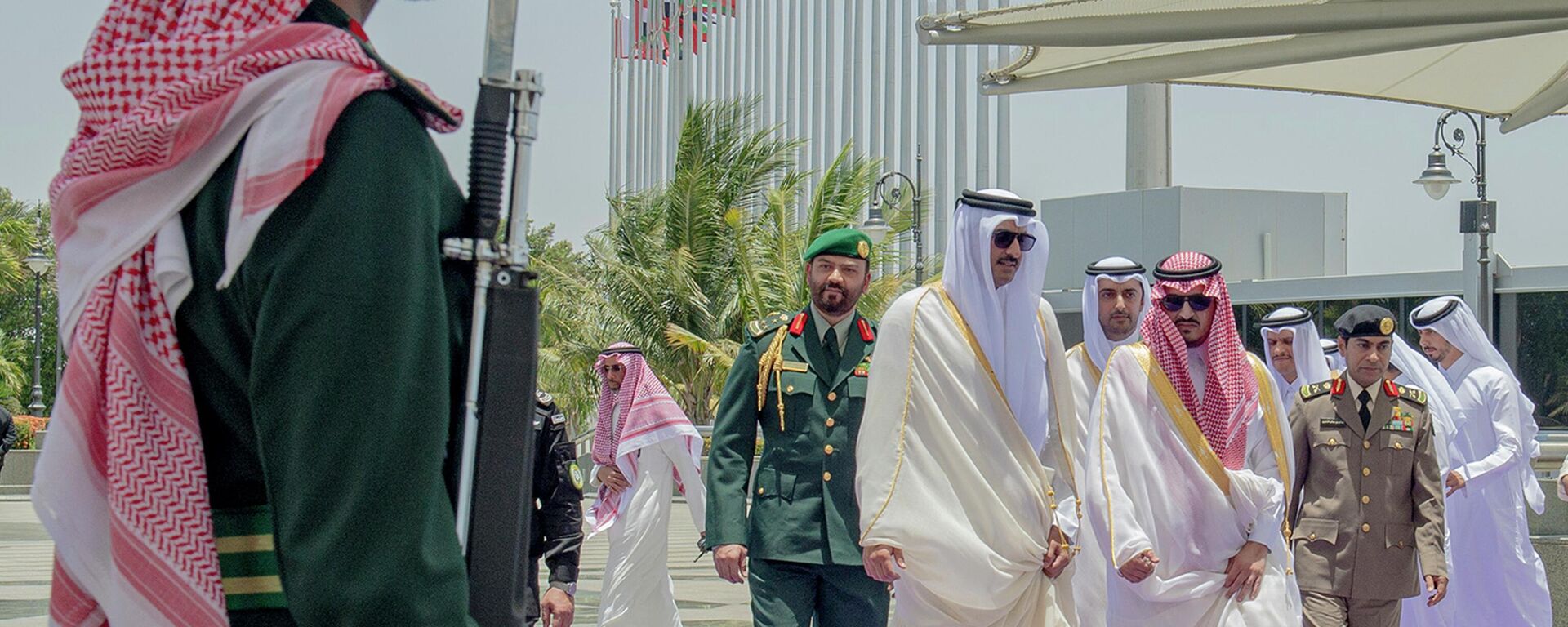 In this photo provided by Saudi Press Agency, SPA, Emir of Qatar Sheikh Tamim bin Hamad Al Thani, center, accompanied by Prince Badr Bin Sultan, deputy governor of Mecca, right, upon his arrival at Jeddah airport, Saudi Arabia, Friday, May 19, 2023, to attend the Arab summit.  - Sputnik Africa, 1920, 09.08.2023