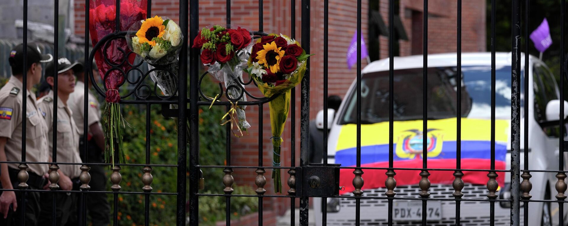 Flowers hang on the cemetery fence where police stand by a vehicle that is part of a funeral procession that will take the remains of slain presidential candidate Fernando Villavicencio - Sputnik Africa, 1920, 12.08.2023