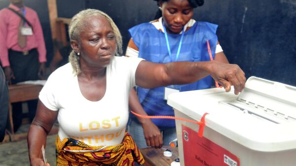 A woman cast her votes during a Presidential runoff election in Monrovia, Liberia.,Tuesday Dec. 26, 2017, Young Liberians went straight from all-night Christmas celebrations to the polls Tuesday for a runoff election between a former international soccer star and the vice president to replace Africa's first female head of state.  - Sputnik Africa