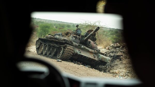 A destroyed tank is seen by the side of the road south of Humera, in an area of western Tigray annexed by the Amhara region during the conflict in northern Ethiopia, on May 1, 2021.  - Sputnik Africa