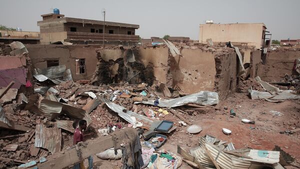 A man walks by a house hit in recent fighting in Khartoum, Sudan, April 25, 2023.  - Sputnik Africa