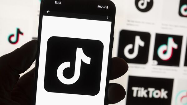 The TikTok logo is seen on a cell phone, Friday, Oct. 14, 2022, in Boston. - Sputnik Africa