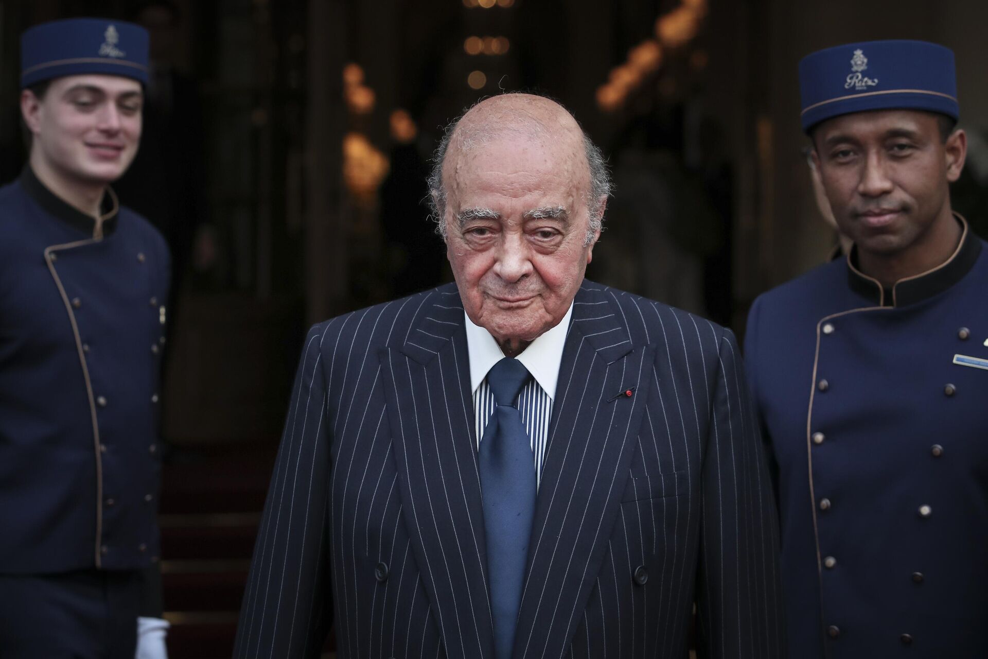 Egyptian businessman and Ritz hotel owner Mohamed Al Fayed poses with his hotel staff in Paris, June 27, 2016. Al Fayed, the former Harrods owner whose son Dodi was killed in a car crash with Princess Diana, has died at age 94. His death was announced Friday, Sept. 1, 2023, by Fulham Football Club, which Al Fayed once owned.  - Sputnik Africa, 1920, 24.12.2023