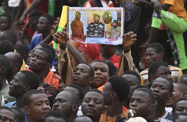 A man holds a placard with the image of Niger&#x27;s new military ruler General Abdourahamane Tiani on as supporters of Niger&#x27;s National Council of Safeguard of the Homeland (CNSP) protest outside the Niger and French airbase in Niamey on September 2, 2023 to demand the departure of the French army from Niger. - Sputnik Africa
