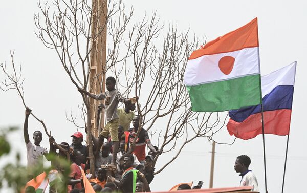 Niger and Russia national flags are seen as supporters of Niger&#x27;s National Council of Safeguard of the Homeland (CNSP) protest outside the Niger and French airbase in Niamey on September 2, 2023 to demand the departure of the French army from Niger.  - Sputnik Africa