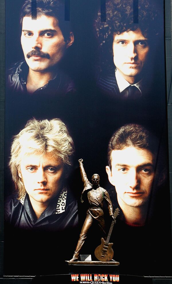 A bronze statue of Freddie Mercury, flanked by other members of the British rock group Queen, clockwise from top right, Brian May, John Deacon and Roger Taylor, looms over Japanese passersby at Tokyo&#x27;s  entertainment district of Shinjuku on Sunday April 24, 2005. The 3-meter tall (9.9-foot) bronze statue of Mercury, who died in 1991, marks the Japanese tour next month of the British musical, &quot;We Will Rock You,&quot; at the Shinjuku Koma Theater.  - Sputnik Africa