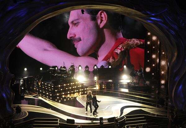 An image of Freddie Mercury appears on screen as Brian May, left, and Adam Lambert of Queen perform at the Oscars on Sunday, Feb. 24, 2019, at the Dolby Theatre in Los Angeles.  - Sputnik Africa