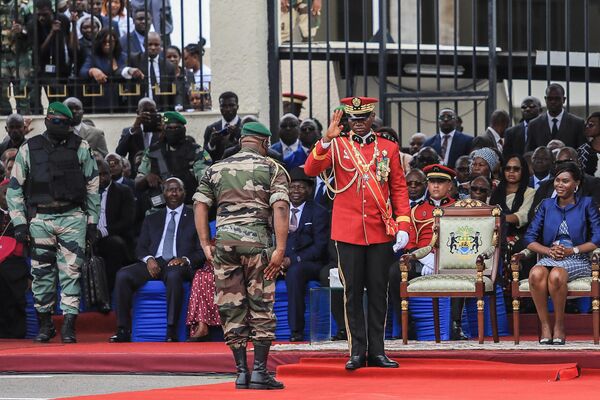 Gabon&#x27;s new strongman General Brice Oligui Nguema, who was inaugurated as Gabon&#x27;s &#x27;interim president&#x27;, salutes as his wife Zita Nyangue Oligui Nguema looks on during the military parade in Libreville on September 4, 2023. Gabon&#x27;s coup leader vowed after being sworn in as &#x27;interim president&#x27; on September 4 to restore civilian rule through &quot;free, transparent and credible elections&quot; after a transition, as well as grant amnesty to prisoners of conscience.  - Sputnik Africa