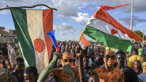 A supporter of Niger's National Council of Safeguard of the Homeland (CNSP) blows his vuvuzela oustide Niger and French airbase in Niamey on September 3, 2023 as protesters gather to demand the departure of the French army from Niger.  - Sputnik Afrique