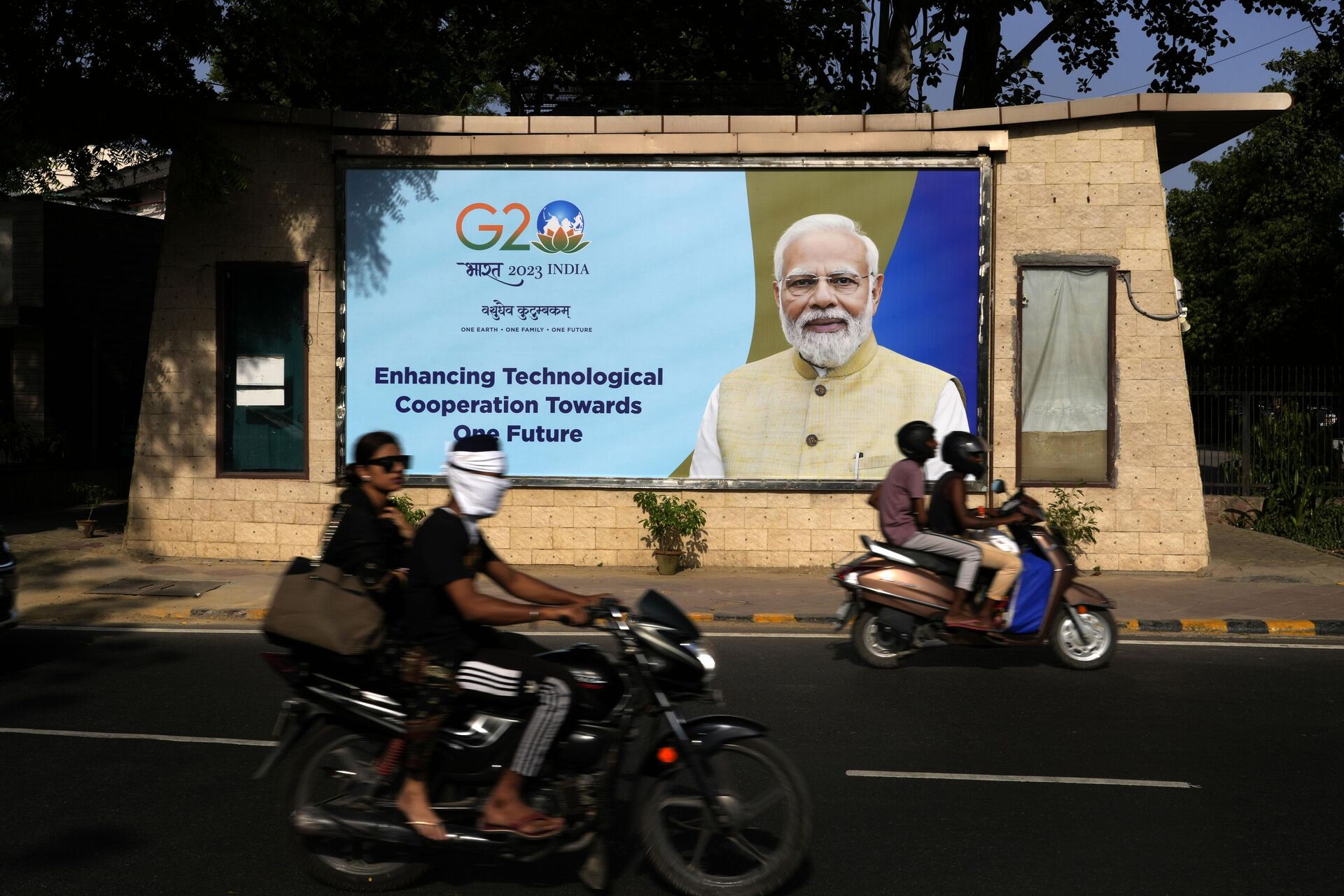 Motorcyclists drive past a billboard featuring Indian Prime Minister Narendra Modi ahead of this week's summit of the Group of 20 nations in New Delhi, India, Monday, Sept. 4, 2023. - Sputnik Africa, 1920, 07.09.2023