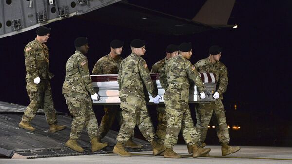 In this Oct. 5, 2017 file photo provided by the U.S. Air Force, a U.S. Army carry team transfers the remains of Army Staff Sgt. Dustin Wright of Lyons, Ga., upon arrival at Dover Air Force Base, Del. Wright was one of four U.S. troops and four Niger forces killed in an ambush by dozens of Islamic extremists on a joint patrol of American and Niger Force. U.S. President Donald Trump’s approach to Africa in his first year in office has been one largely of neglect - and then suddenly one of shocking insult. The killings of the four U.S. soldiers in the West African nation of Niger set off outrage, along with questions about why the U.S. military was there at all - Sputnik Africa