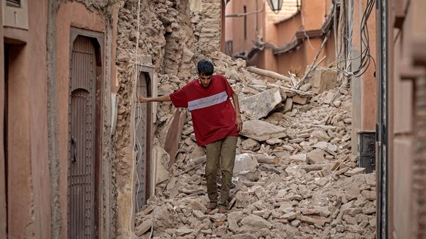 A resident navigates through the rubble following a 6.8-magnitude quake in Marrakesh on September 9, 2023 - Sputnik Africa