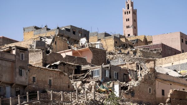 The minaret of a mosque stands behind damaged or destroyed houses following an earthquake in Moulay Brahim, Al-Haouz province, on September 9, 2023 - Sputnik Africa