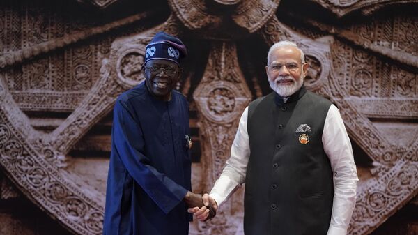 Indian Prime Minister Narendra Modi, right, shakes hand with Nigeria President Bola Ahmed Tinubu upon his arrival at Bharat Mandapam convention centre for the G20 Summit in New Delhi, India, Saturday, Sept. 9, 2023.  - Sputnik Africa