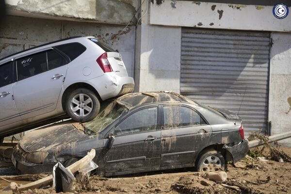 Cars sit, one stacked on top of the other, after being carried by floodwaters in Derna. - Sputnik Africa