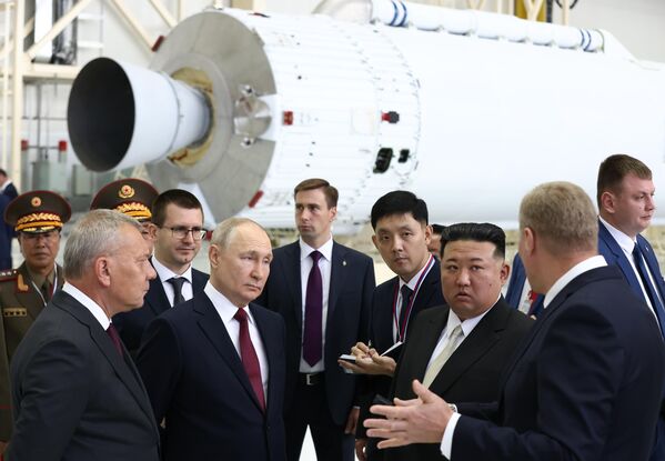 Russian President Vladimir Putin and North Korean leader Kim Jong Un at the Vostochny Spaceport. On the left: head of Russian state space corporation Roscosmos Yuri Borisov. - Sputnik Africa