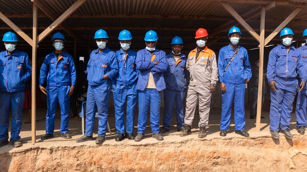 Workers pose outside a trading depot in the artisanal copper-cobalt mine of Kamilombe, near the city of Kolwezi in southeastern Democratic Republic of Congo - Sputnik Africa