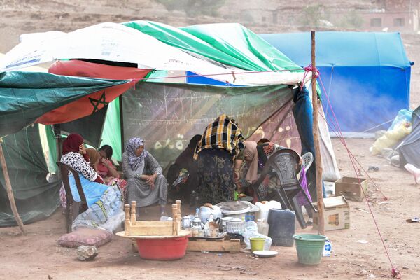 People gather in tents in the earthquake-hit village of Ardouz, in Morocco&#x27;s Amizmiz region on September 14, 2023.  - Sputnik Africa