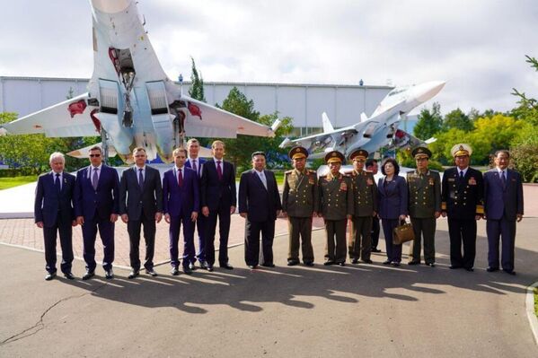 North Korean leader Kim Jong Un, Russian Minister of Industry and Trade Denis Manturov, Khabarovsk Governor Mikhail Degtyarev, and other participants pose for a joint photo during the meeting at the aviation plant named after Soviet cosmonaut Yuri Gagarin, Komsomolsk-on-Amur, September 15, 2023. - Sputnik Africa