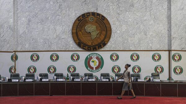 An ECOWAS staff member walks past a stage before a press conference organized by the Commonwealth, The Economic Community of West African States (ECOWAS) and the Africa Union (AU) at the ECOWAS head quarter in Abuja on February 27, 2023. - Sputnik Africa