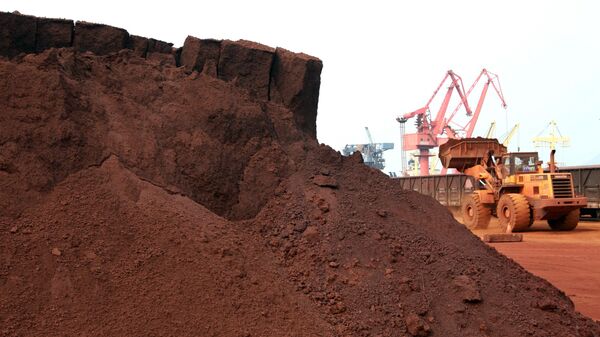
In a picture taken on September 5, 2010 a man driving a front loader shifts soil containing rare earth minerals to be loaded at a port in Lianyungang, east China's Jiangsu province, for export to Japan.  - Sputnik Africa