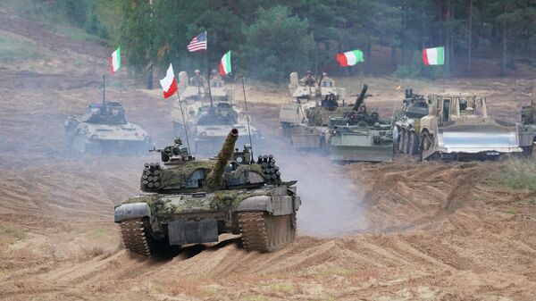 Military vehicles and tanks of Poland, Italy, Canada and United States roll during the NATO military exercises ''Namejs 2021'' at a training ground in Kadaga, Latvia, on Monday, Sept. 13, 2021. - Sputnik Africa