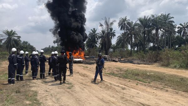 Fire fighters and security officers are seen at the site of an illegal refinery explosion In Emuoha council area of the southern Rivers, Nigeria, Friday, March 3, 2023.  - Sputnik Africa