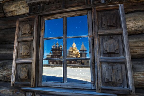 Reflection of the wooden churches of the architectural ensemble observed through the window of Peasant Oshevnev&#x27;s House in the village of Oshevnevo, as part of the exposition at the State Kizhi Museum. - Sputnik Africa